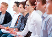 Group of students studying together in classroom