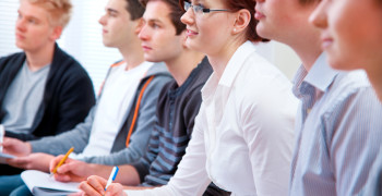 Group of students studying together in classroom